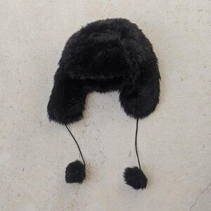 Black faux fur trapper hat with pom poms